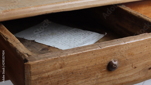 Billede på lærred Half open drawer of old vintage wooden table close-up with an old handwritten l