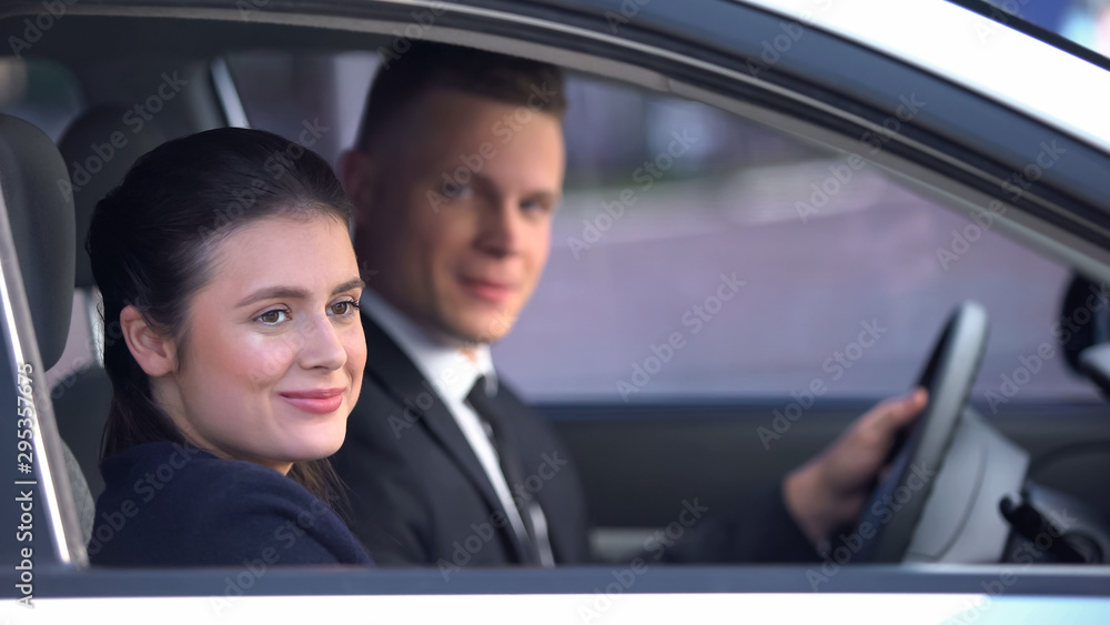 Young couple sitting happily in car after romantic date, loving relationship Young couple sitting happily in car after romantic date, loving relationship