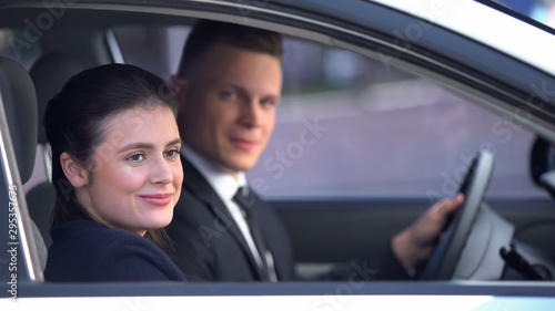Young couple sitting happily in car after romantic date, loving relationship © motortion