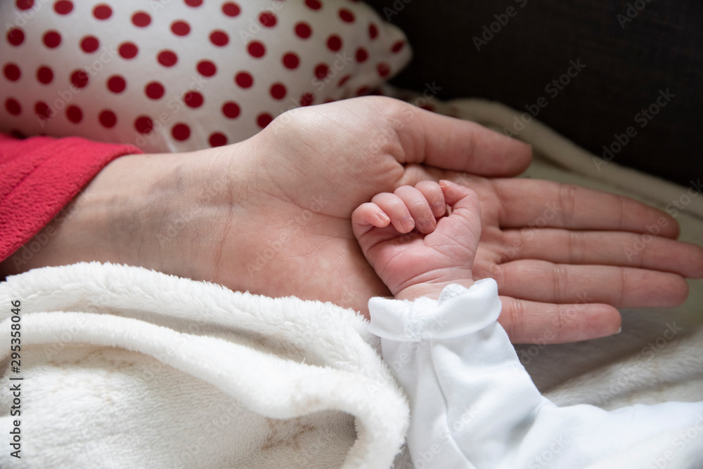 Hand in hand with mother son son in an act of tenderness. The newborn gets in touch with his mother through body contact. Hand in hand with mother son son in an act of tenderness. The newborn gets in touch with his mother through body contact.