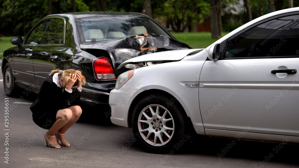 Frustrated woman covering head, car accident despair, driver suffering stress Frustrated woman covering head, car accident despair, driver suffering stress