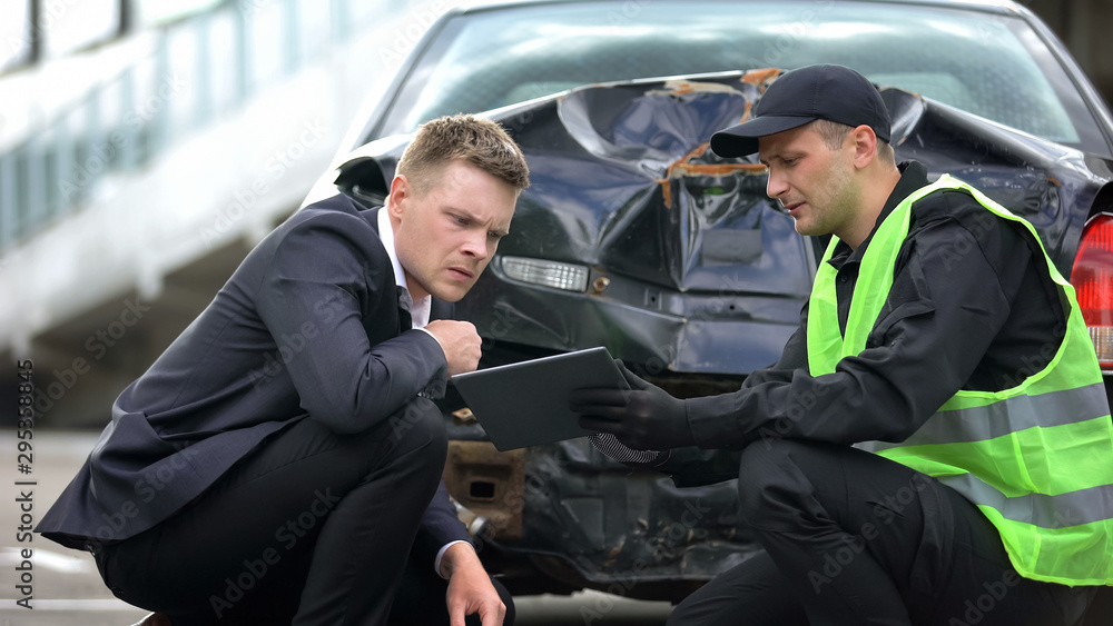 Patrol worker showing driver online tablet report, modern technology, accident Patrol worker showing driver online tablet report, modern technology, accident