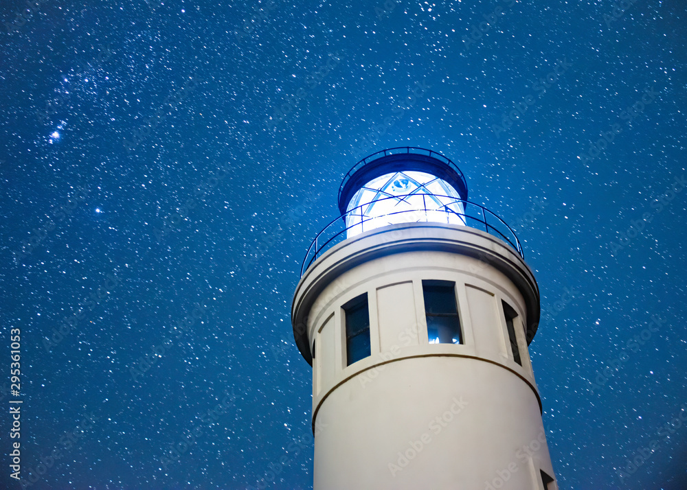 Low Angle Lighthouse with Star-Filled Night Sky