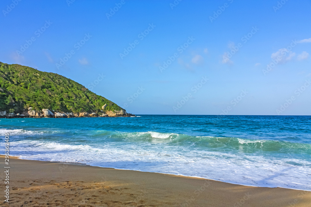 Caribbean beach with tropical forest in Tayrona National Park, Colombia. Tayrona National Park is located in the Caribbean Region in Colombia.
