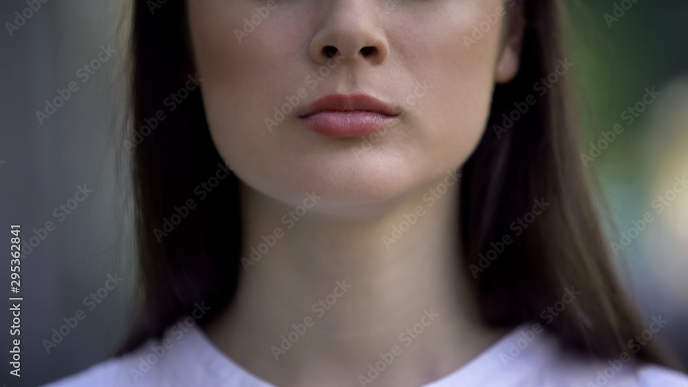 Close-up of serious woman face looking at camera, political protest, freedom Close-up of serious woman face looking at camera, political protest, freedom