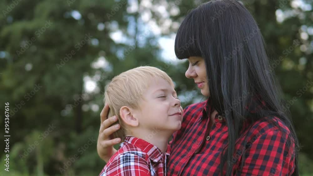 happy family mom and son concept . mom tender childhood video . slow lifestyle motion video . mom a brunette girl gently hugs takes care of the boy son blonde outdoors happy family mom and son concept . mom tender childhood video . slow lifestyle motion video . mom a brunette girl gently hugs takes care of the boy son blonde outdoors