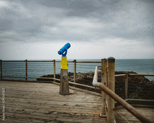 Telescope overlooking ocean with overcast