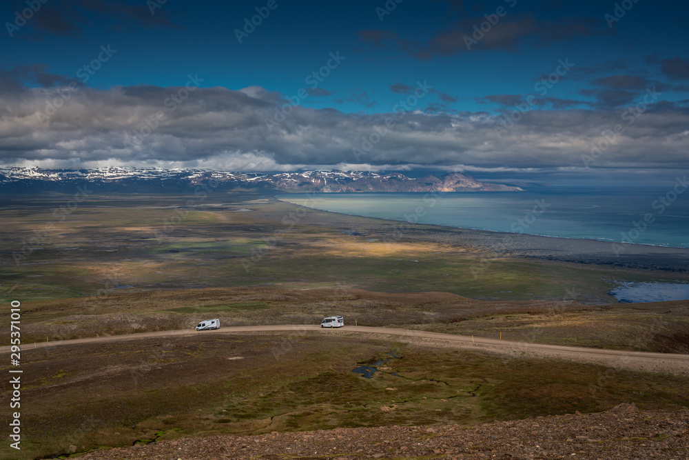 Two white campers on the icelandic road.