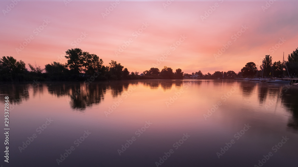 dawn on the lake early autumn / silhouette of trees on the background of dawn dawn on the lake early autumn / silhouette of trees on the background of dawn