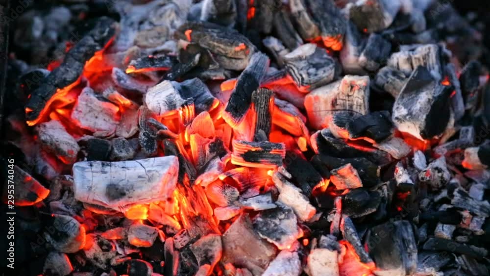 Closeup of warm fire burning in a campfire with hot charcoals Closeup of warm fire burning in a campfire with hot charcoals