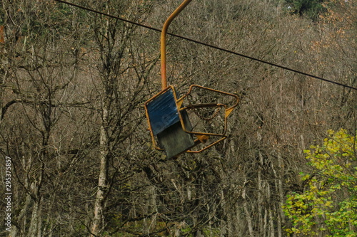 Chairlift on the Caucasus Mountains. Old unworking chairlift in the forest.