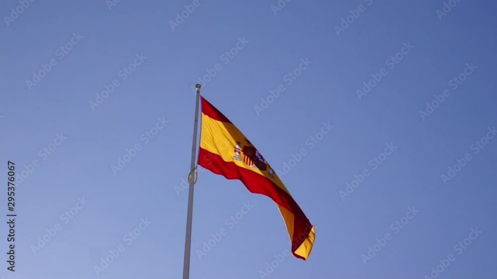 Isolated Spain flag fluttering with blue sky background Isolated Spain flag fluttering with blue sky background