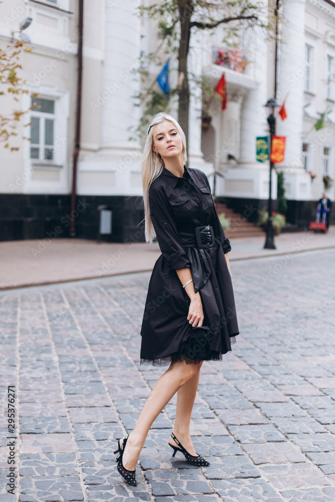 Fashion photosession of professional model in the city in trendy black dress. Fashion , trendy concept
