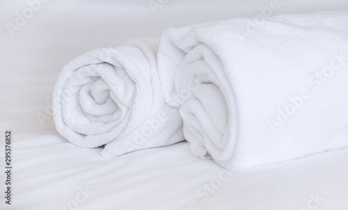 Two towels on the bed in hotel room