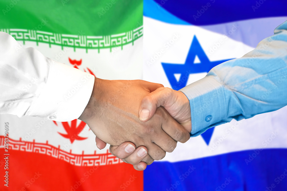 Handshake on Iran and Israel flag background.