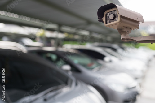 CCTV security camera on blur car parking