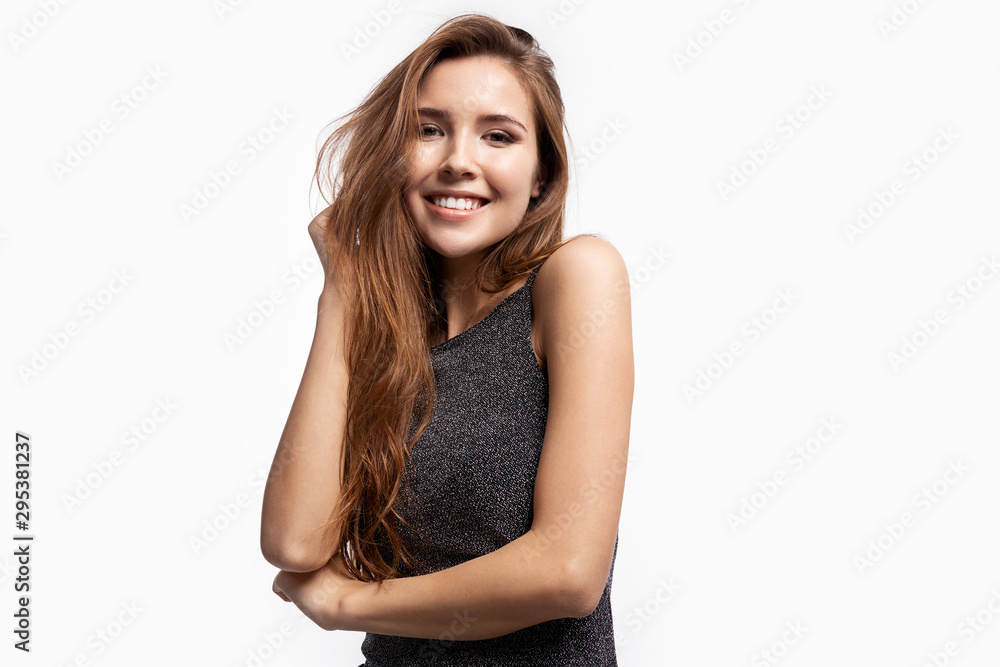 Happy portrait of smiling young woman in shiny black shirt laughing and posing on camera. Well-dressed lady with pretty hairstyle. Happiness and lifestyle concept. Isolated on white Happy portrait of smiling young woman in shiny black shirt laughing and posing on camera. Well-dressed lady with pretty hairstyle. Happiness and lifestyle concept. Isolated on white