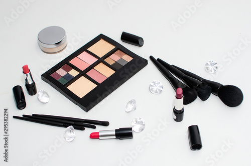 Assorted cosmetics, lipstick, eyeshadow Palette, Makeup Brush, isolated on white background