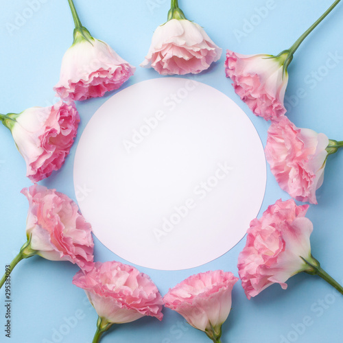 Gentle pink eustoma flowers on a blue astel paper background. photo