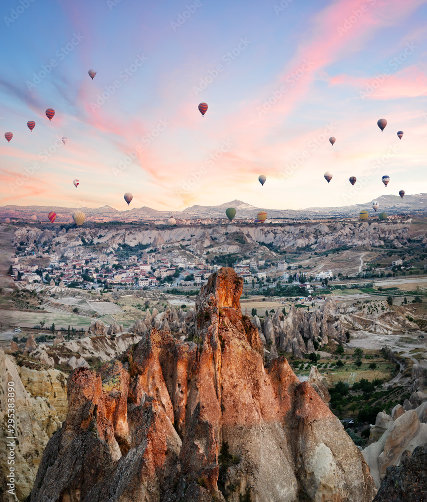 Balloons over rocks of Cappadocia in early morning