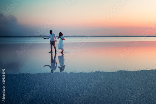 Newlyweds are walking on water of salt lake Tuz photo