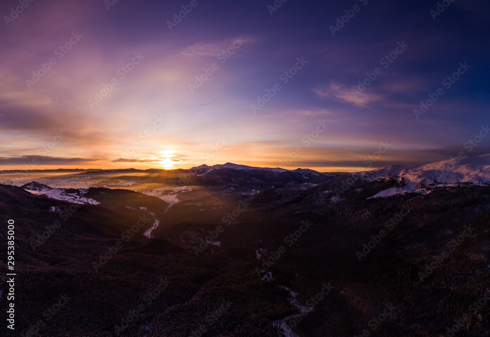 Stunning winter panorama with trees and hills