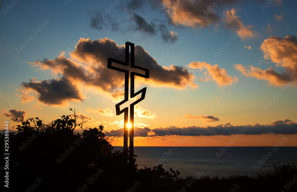 Christian cross on the background of the sea and sunset Christian cross on the background of the sea and sunset