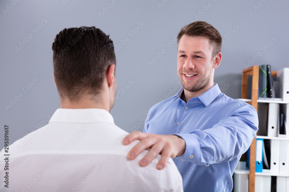 Smiling Boss Congratulating Colleague For His Success Smiling Boss Congratulating Colleague For His Success