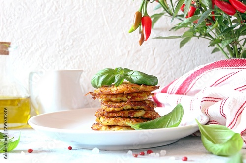 Fried potato pancakes on light background. Top view with copy space.