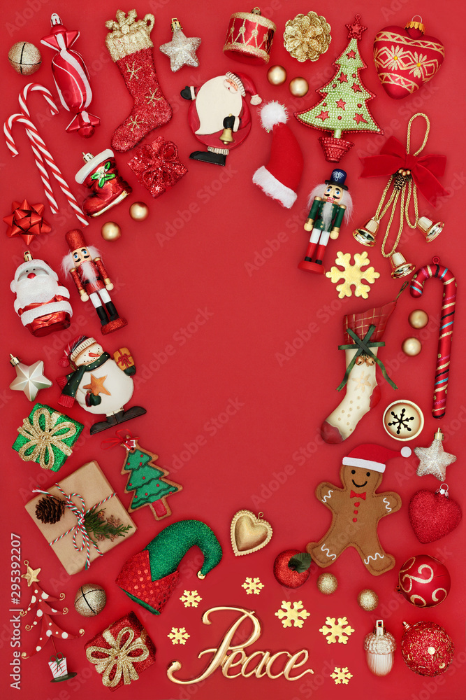 Christmas background border with gold peace sign, tree decorations, symbols and ornaments on red background with copy space. Traditional theme with symbols for the festive season.