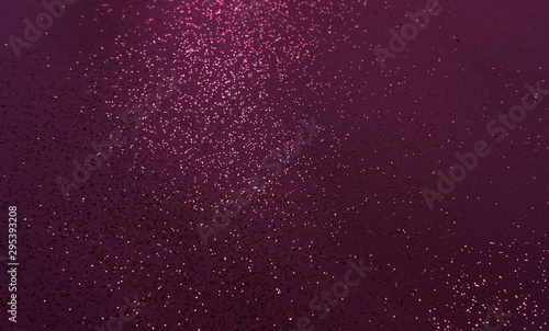 Golden sparkles dark grape background.