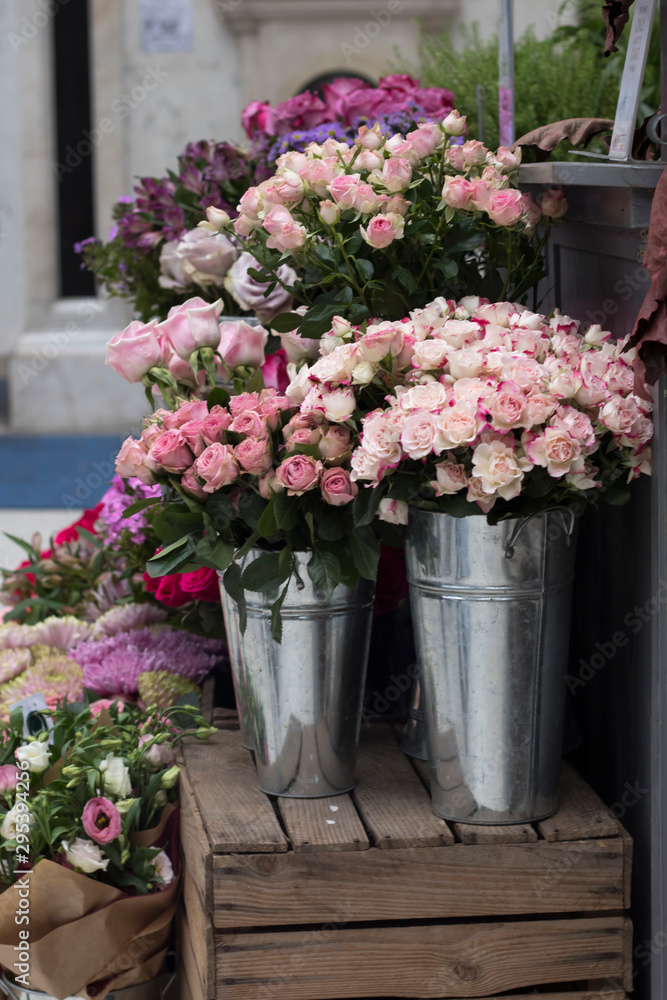 Bouquets of pink roses and carnations in wedding bouquets, packed in cellophane for sale