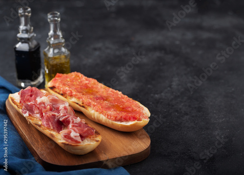 Spanish tomato and ham toast, traditional breakfast or lunch photo