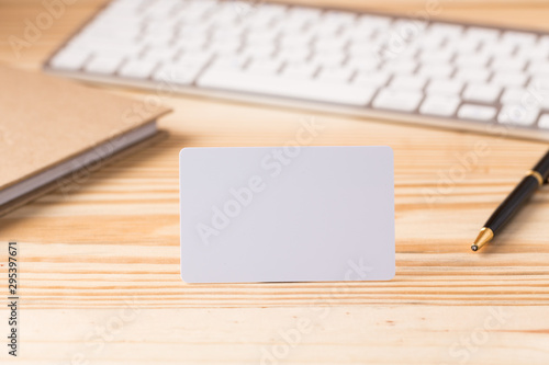 Blank credit card on office table with keyboard and note book