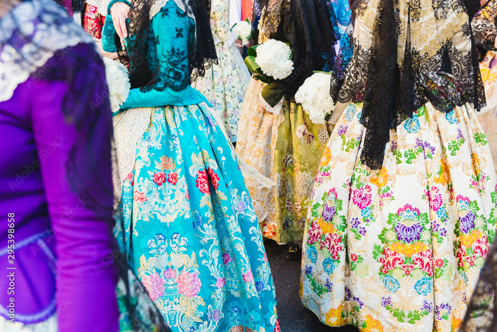 Detail of the traditional Spanish Valencian Fallera dress, colorful fabrics with intricate embroidery.