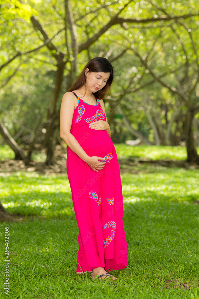 Portrait asian beautiful belly pregnant in public park Portrait asian beautiful belly pregnant in public park