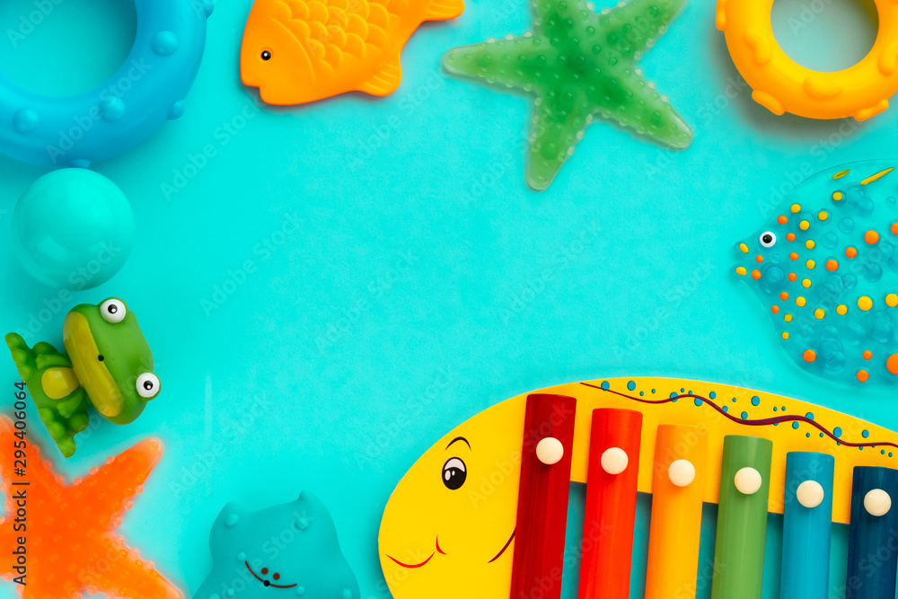 Top view on children's educational and music games, frame from multicolored  kids toys on light blue paper background. Circles, fish, frog, starfish,  xylophone. Sea, ocean concept. Flat lay, copy space Stock Photo |