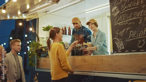 Food Truck Employee Hands Out a Freshly Made Burger to a Happy Young Female
