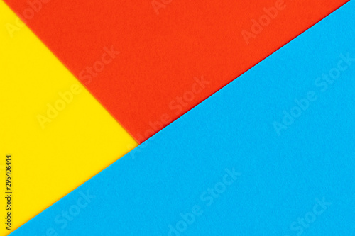 Yelllow blue red color paper background. Geometric figures, shapes. Abstract geometric flat composition. Empty space on monochrome cardboard.