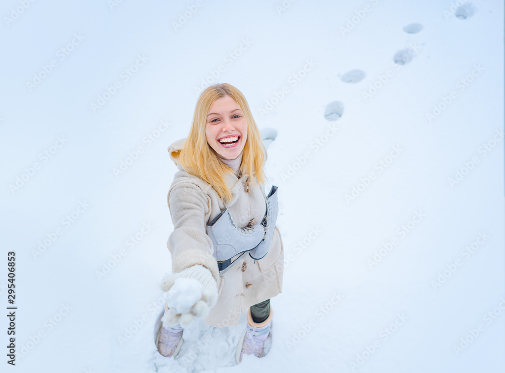 Outdoor photo of young beautiful happy smiling girl walking on white snow Background. Beautiful woman enjoying first snow. Outdoor photo of young beautiful happy smiling girl walking on white snow Background. Beautiful woman enjoying first snow.