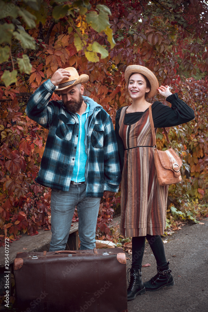 Happy girl fall in love with bearded man. Attractive couple having a romantic moment together, dressing in traditional rural style sitting close to each other on an autumn day. The concept of genuine