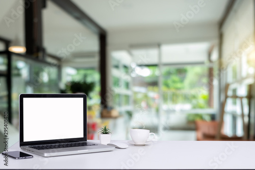 Desk Laptop with blank screen on table blur background with bokeh background