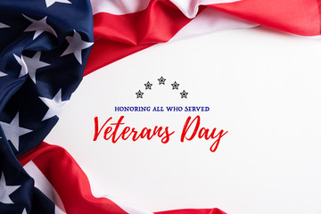Happy Veterans Day. American flags with the text thank you veterans against a white background. November 11.