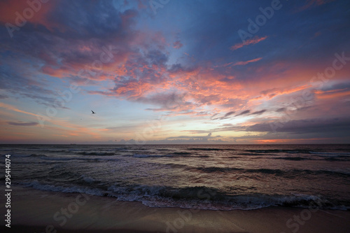 Sunrise on Miami Beach's South Beach, Florida under dramatic cloudscape.