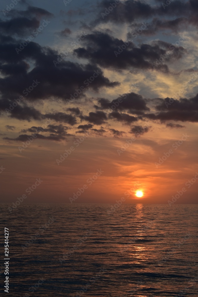 Fototapeta premium Beautiful orange sunset over the water