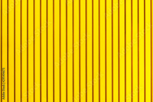 Horizontal shot of vertical yellow plastic panels texture. Exterior or interior design concept. Front view