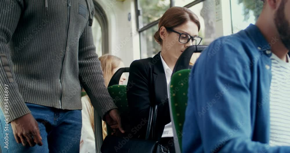 Different Caucasian people going in the tram. Businesswoman and young stylish guy sitting in the tram and then being shocked and angry with something what happening. Different Caucasian people going in the tram. Businesswoman and young stylish guy sitting in the tram and then being shocked and angry with something what happening.