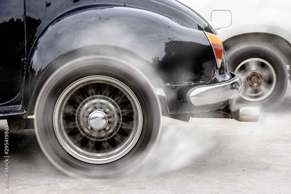 vintage car spinning wheel burns rubber on floor