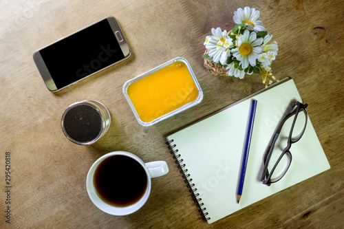 note book with coffee pencil speaker and smartphone on desktop