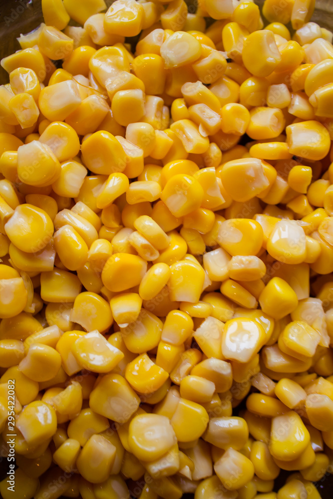 Canned corn in a plate before cooking. Corn background. Canned corn in a plate before cooking. Corn background.